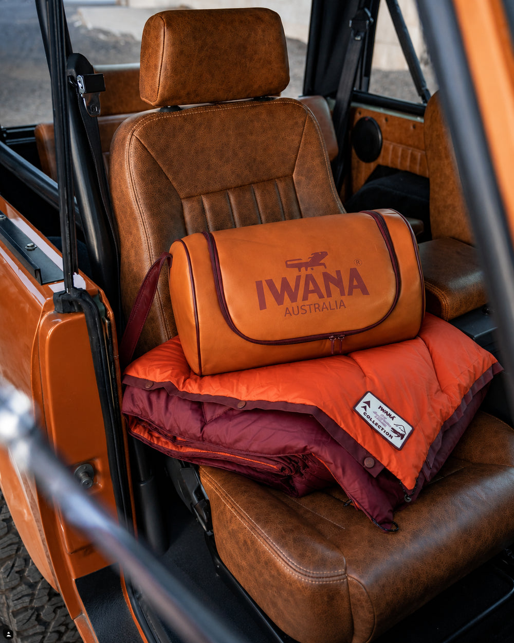 IWANA Campfire outdoor blanket rolled in its carry bag on a car seat
